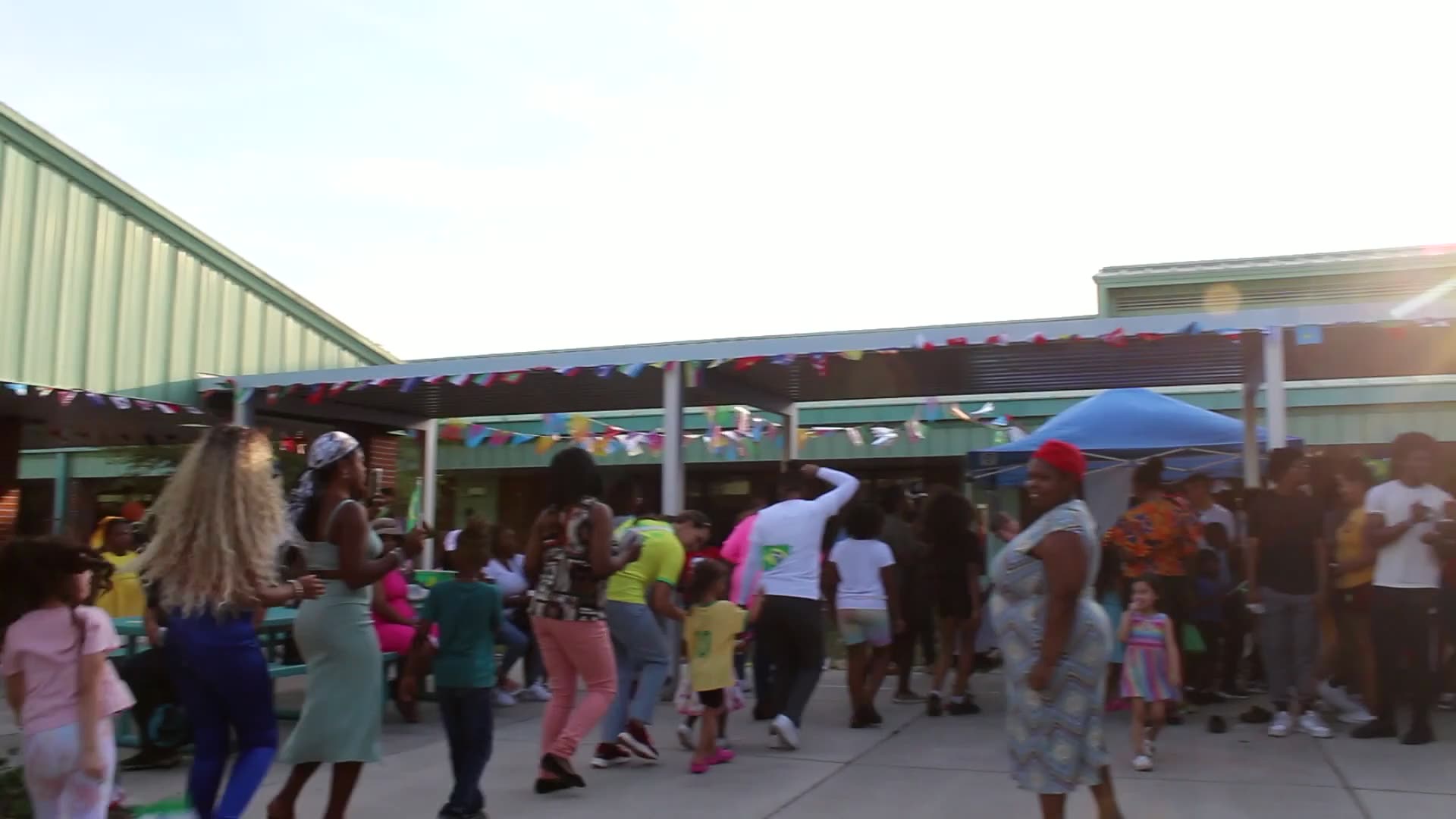 Families dancing together at Cultural Day