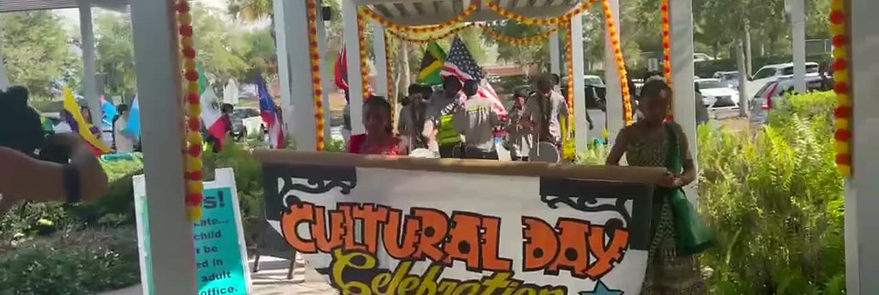 Students carrying the Cultural Day Celebration banner through the school