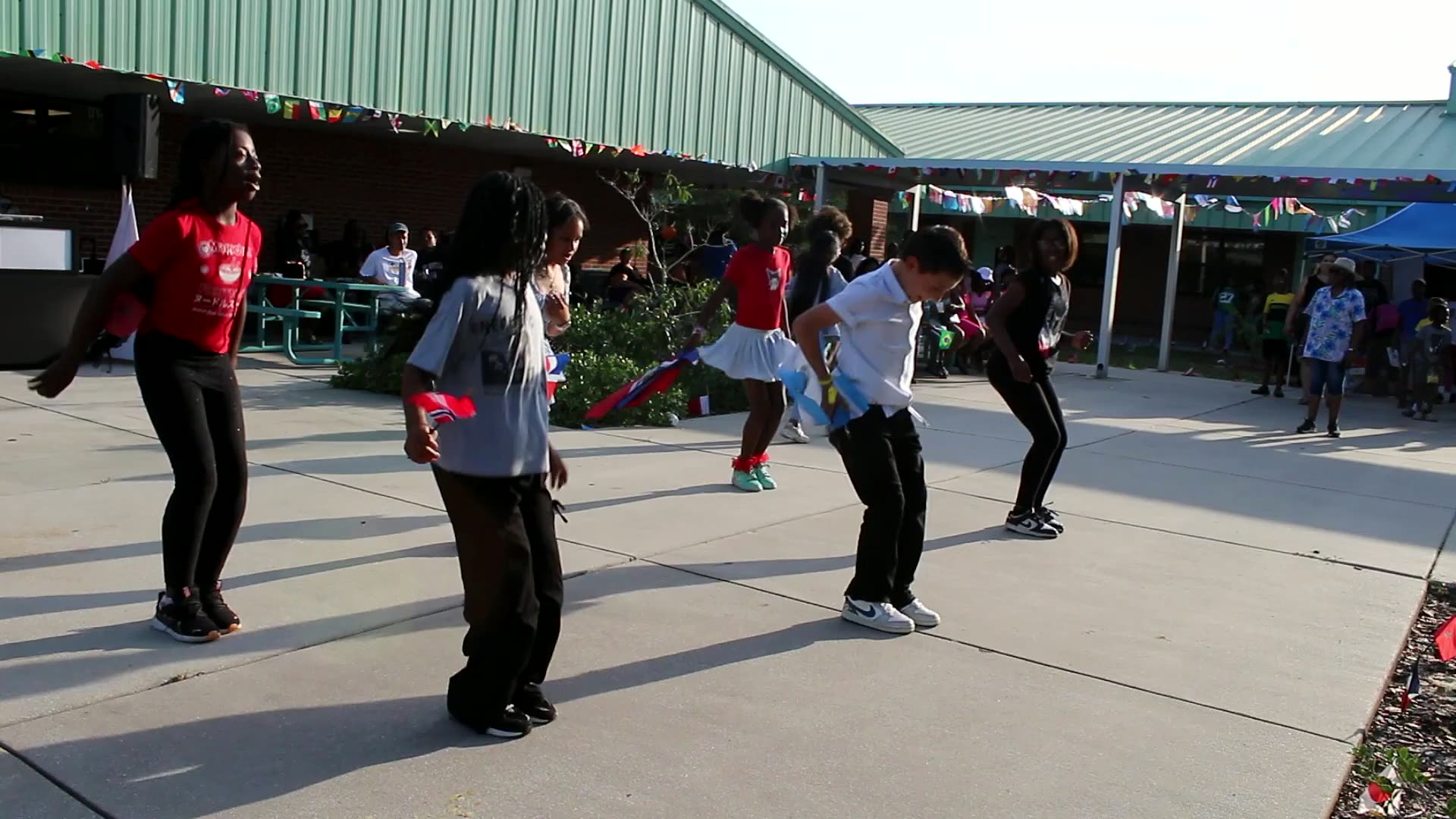Students performing a dance routine in the school courtyard