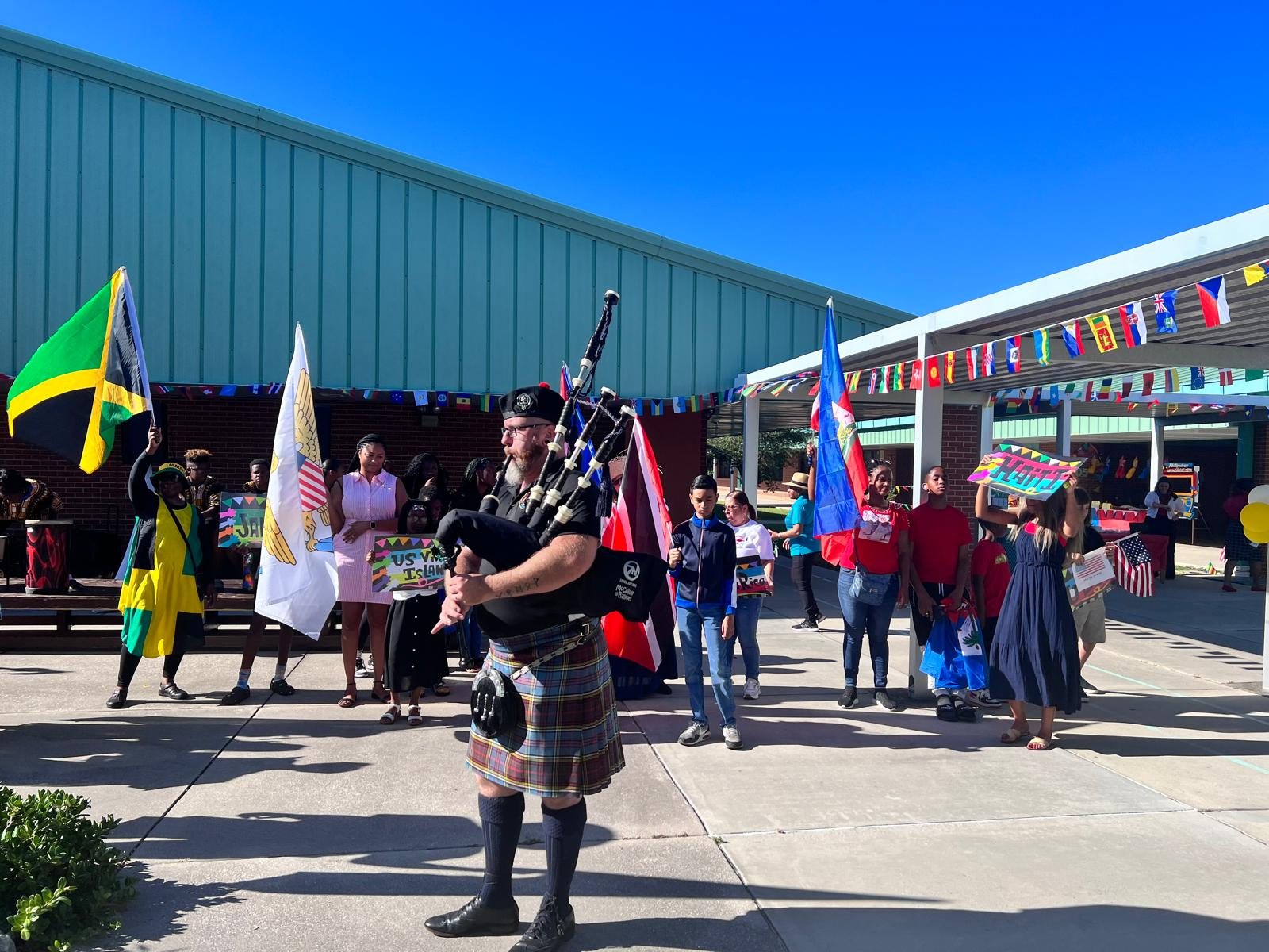 A bagpiper leading the Cultural Day parade at Pinewood Elementary