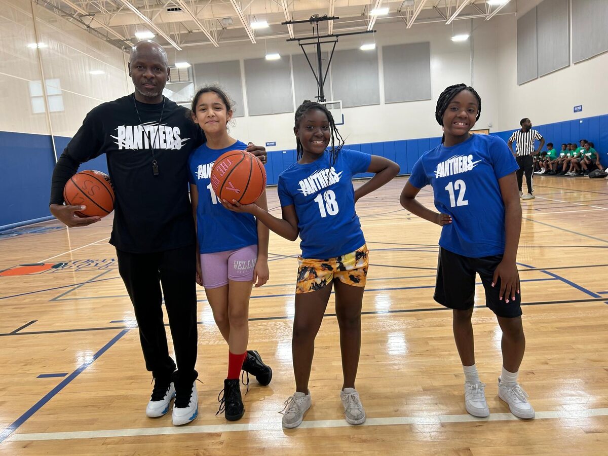 The girls basketball team together on the court